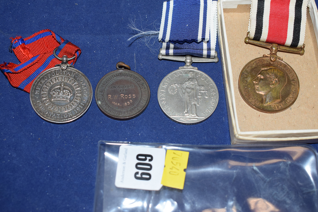 A Police Exemplary Service medal and a Royal Life Saving Society medal 1933 awarded to Constable