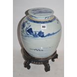 19th Century Chinese blue and white ginger jar with cover and carved stand.