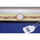 A 9ct. yellow gold wristwatch with white enamel roman numeral dial, 28.5grms gross.