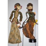 A painted wood Balinese puppet; together with another on a stand, 67cms high.