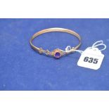 A 9ct. yellow gold bangle set with an amethyst, 6.2grms gross.