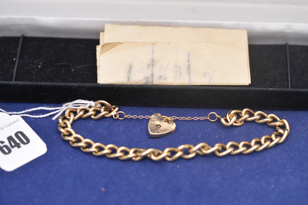 A 9ct. yellow gold chain link bracelet with heart shaped clasp, 27.2grms.