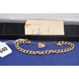 A 9ct. yellow gold chain link bracelet with heart shaped clasp, 27.2grms.