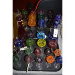 Bohemian coloured glass, to include: wine glasses and liqueur glasses; together with two decanters.