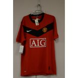 Manchester United replica football shirt signed by Eric Cantona; with a photograph of Eric