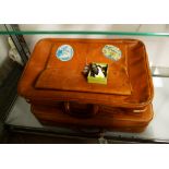 Two small leather suitcases; together with Royal Artillery military buttons and badges.