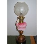 A Victorian brass and glass oil lamp.