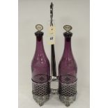 A pair of amethyst glass decanters