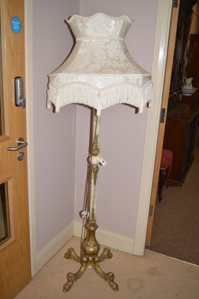 An early 20th century cast brass and onyx standard lamp.