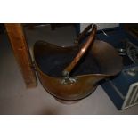 A copper coal scuttle.