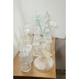 12 Cut glass and crystal decanters; together with a cut glass claret jug and a cut glass biscuit