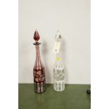 A pair of coloured glass decanters in white and red