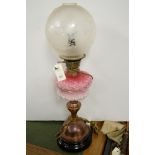 A Victorian brass and glass oil lamp.