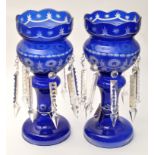 Pair of blue overlay glass table lustres, decorated with cut geometric forms,