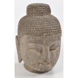 Hardstone Buddha head, with tightly curled hair pulled up in a chignon having drilled detailing,