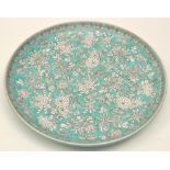 Chinese white enamel and turquoise ground charger, the interior with floral scatter,