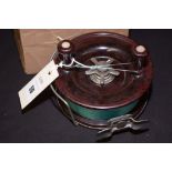 A large chromed metal bakelite fishing reel, bearing a label inscribed "Alvey" snapper reel, No.