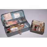 A metal cantilever fishing tackle box, containing: flies, lures, lead weights,