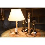 A pair of modern wooden bedside table lamps,