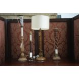 A turned oak candlestick style table lamp; two other turned wooden table lamps,