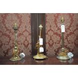 Three early 20th Century brass table lamps, various, with weighted bases (no shades).