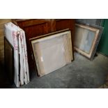 A collection of assorted large empty glazed picture frames.