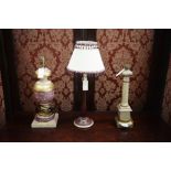 Three modern painted table lamps, one with a shade.