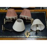 Two pairs of modern cantilever brass wall light fittings, one with pink shades,