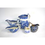 The Coysh Collection - Four 19th century blue transfer decorated jugs comprising: Sauce boat