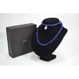 A lapis lazuli facetted bead necklace within fitted box