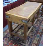 A substantial old butchers block with steel bracketed corners, raised on a square section frame,