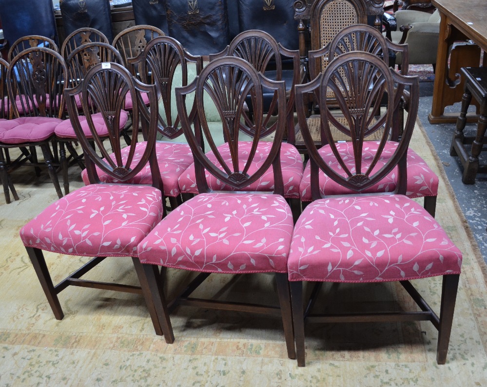 A set of six George III mahogany side chairs with arched crests over pierced fan splats and