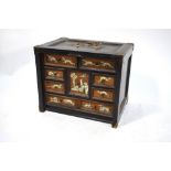 An 18th century Continental ebonised box fitted with an arrangement of eight small drawers inlaid