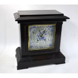 A Victorian Aesthetic movement ebonised mantle clock of architectural form,