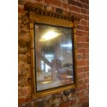 A Regency giltwood pier glass with moulded frieze, the plate flanked by cluster pilasters,