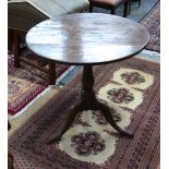 An 18th century country oak tripod table, the circular snap top over a birdcage,