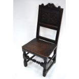 A 17th century joint oak carved and panelled chair