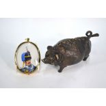 A bronze novelty 'pig' counter-bell with clockwork movement, 17 cm long,
