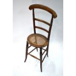 A Victorian beech framed cane seat correction chair