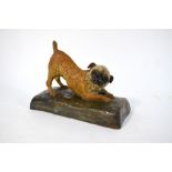 Stella R Crofts - 'Podge' a glazed terracotta figure of a border terrier, guarding his ball,