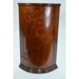 A small figured walnut bowfront hanging corner cupboard Condition Report Good
