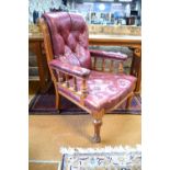 An oversized Victorian oak framed buttoned red leather library armchair on turned front legs to