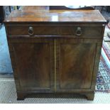 A Victorian mahogany cabinet with full width frieze drawer over a pair of panelled doors,