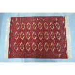 A fine Turkman rug, the red ground with well spaced guls,