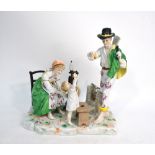A German porcelain group of a young peasant family, the father offering a peach to the infant child,
