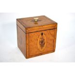 A Sheraton style inlaid satinwood cuboid tea caddy with floral and foliate medallions,