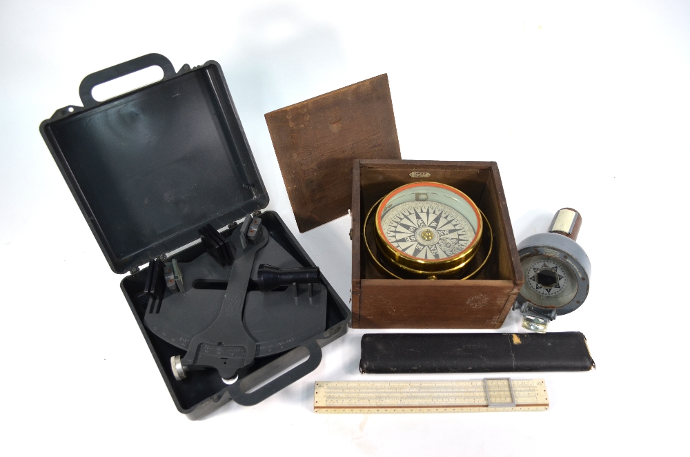 A late 19th century brass gimbal compass with printed paper 12 cm dial,