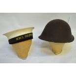 A vintage flying hat, a military tin hat, an HMS Dolphin naval cap, a fencing face guard,