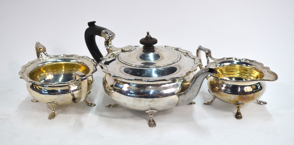 A heavy quality silver three-piece tea service of compressed globular form with shaped rims and