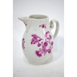 An 18th century English porcelain pear-shaped jug with reeded lip and scroll handle,